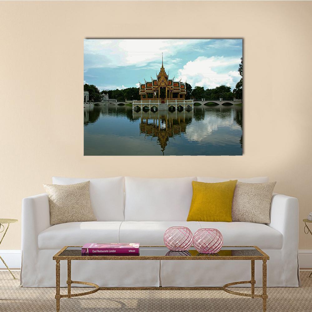 Golden Thai Pavilion with Lake Reflection Canvas Wall Art in gold, green and blue, single panel hung on a wall