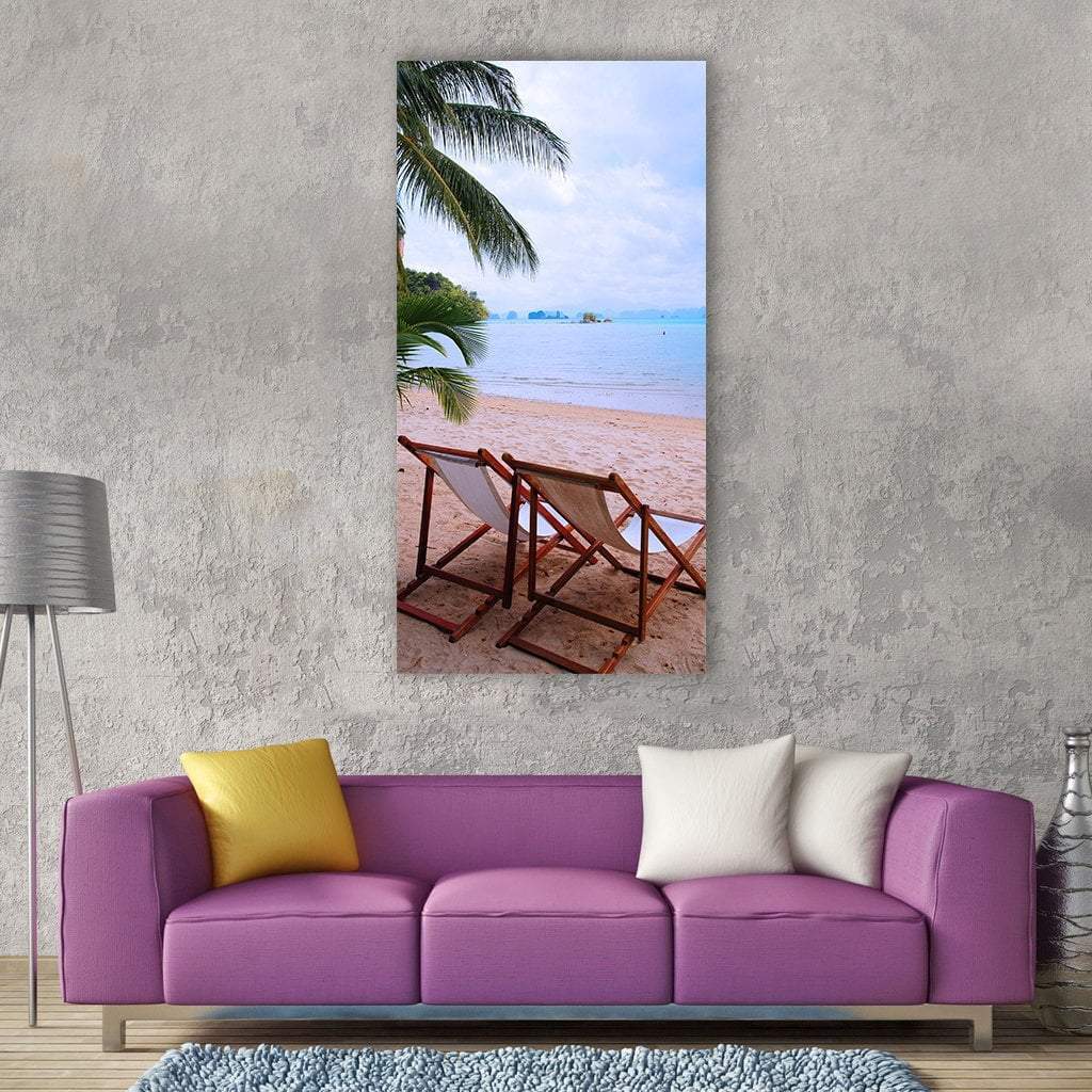 Two Beach Chairs Facing the Ocean Vertical Canvas Wall Art in beige, brown and blue, single vertical panel hung on a wall
