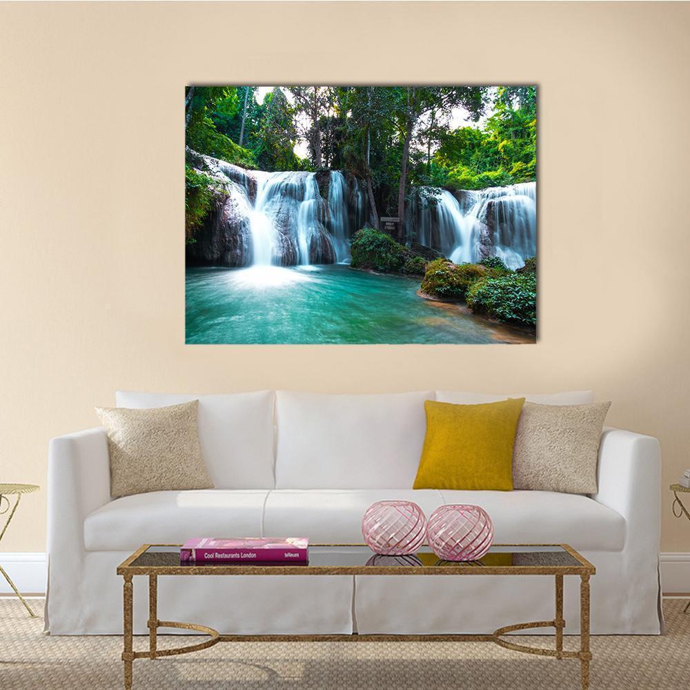 Than Sawan Waterfall with Turquoise Pool Canvas Wall Art in white, green and blue, single panel hung on a wall