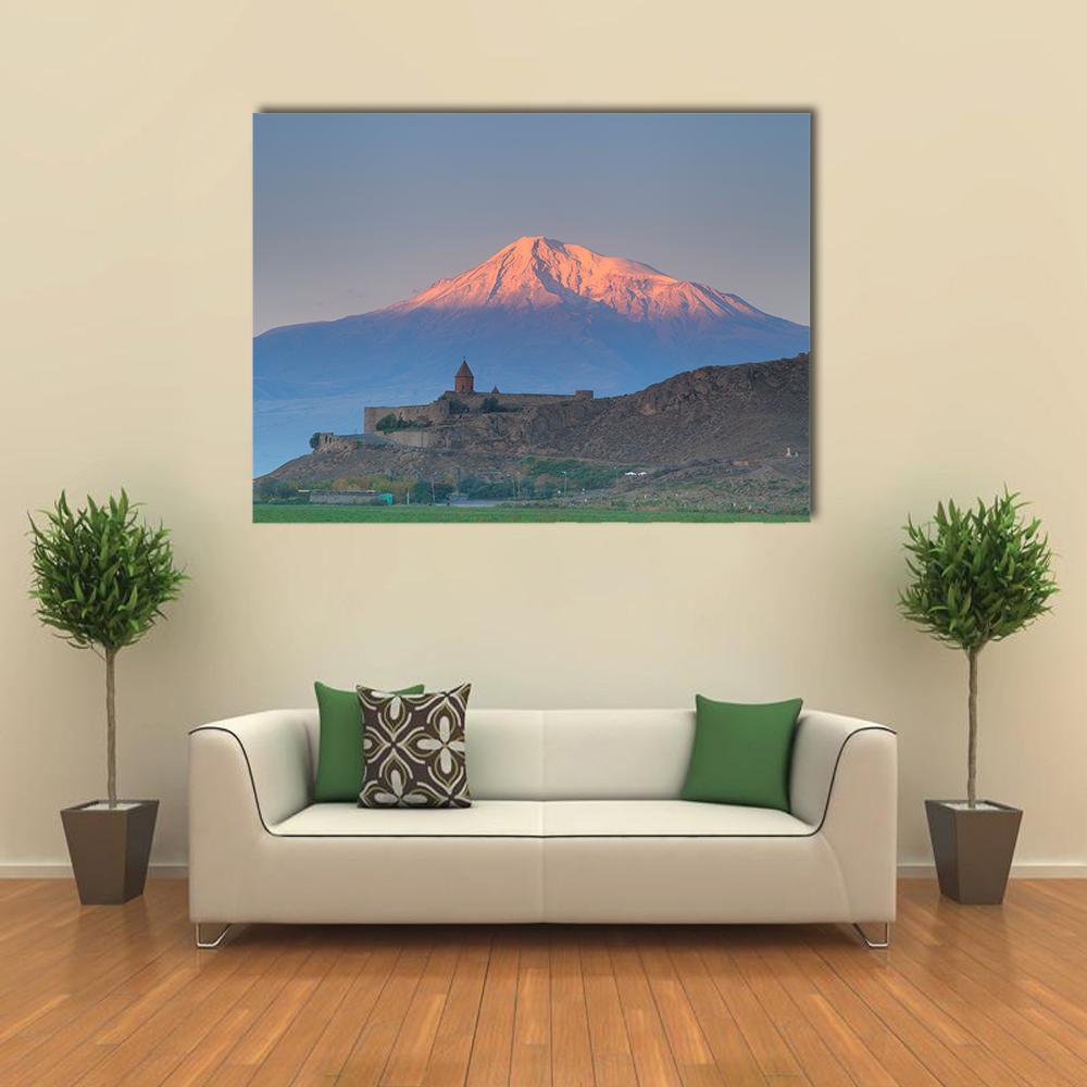 Khor Virap Church on Hill with Snow-capped Mountain Canvas Wall Art in white, blue and pink, single panel hung on a wall
