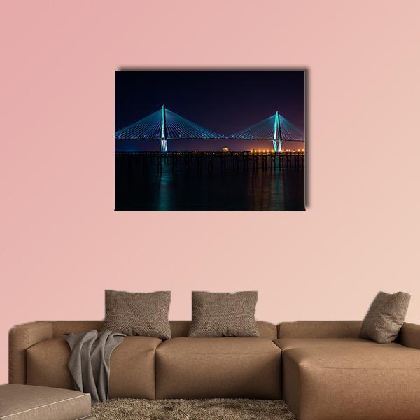 Arthur Ravenel Bridge at Night Canvas Wall Art in black and blue, single panel hung on a wall