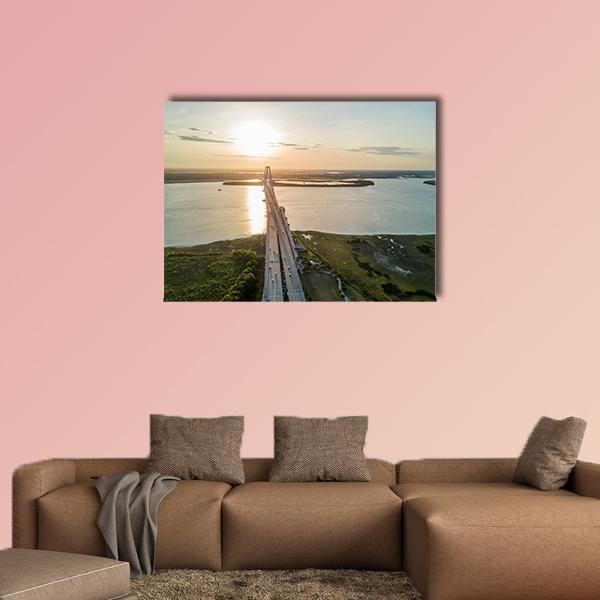 Arthur Ravenel Jr Bridge at Sunset Canvas Wall Art in yellow, green and blue, single panel hung on a wall
