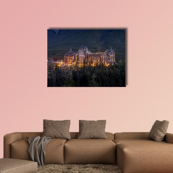 Banff Springs Hotel at Night Canvas Wall Art in black, yellow and blue, single panel hung on a wall