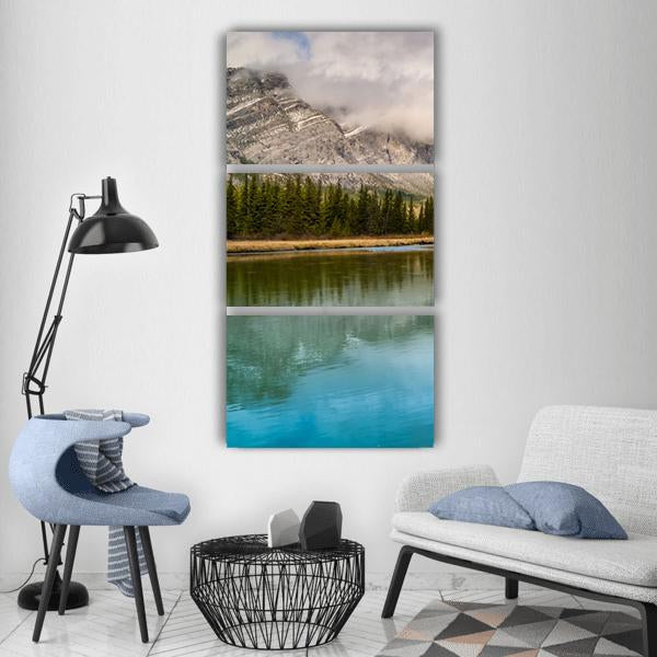 Bow River Reflections Vertical Canvas Wall Art in gray, green and blue, hung on a wall
