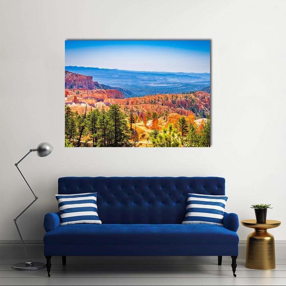 Bryce Canyon Hoodoos with Pine Trees Canvas Wall Art in orange, green and blue, single panel hung on a wall