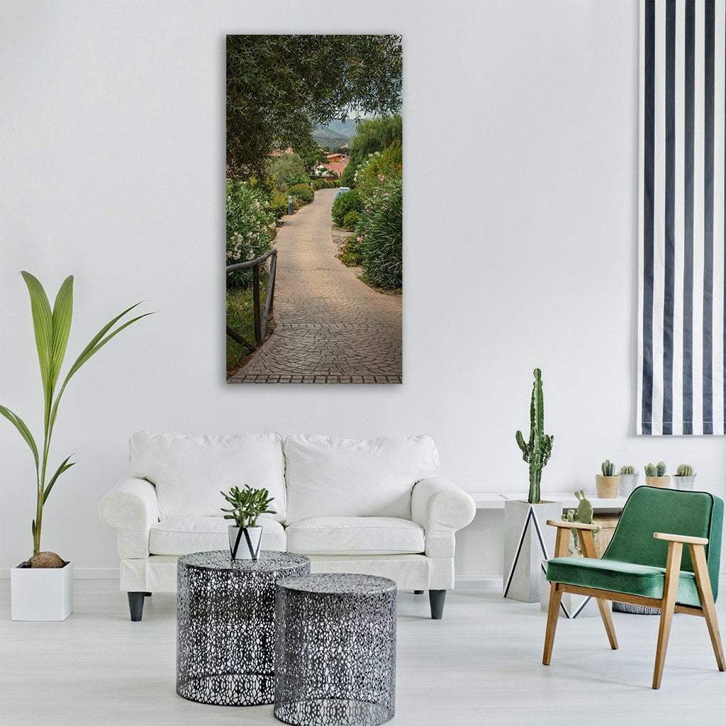 Winding Cobblestone Garden Path Vertical Canvas Wall Art in gray, beige and green, single vertical panel hung on a wall