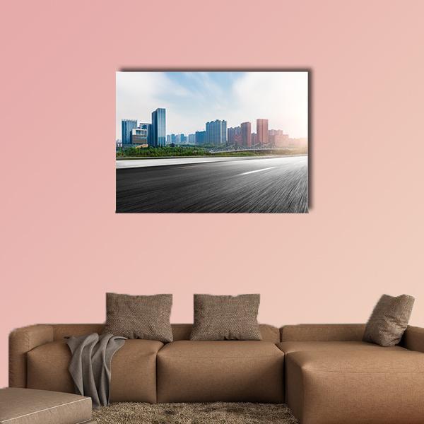 City and Road with Motion Blur Canvas Wall Art in black, gray and blue, single panel hung on a wall