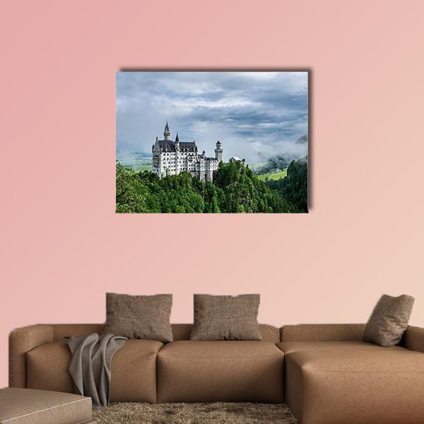 Neuschwanstein Castle on a Forested Hill Canvas Wall Art in gray, green and blue, single panel hung on a wall