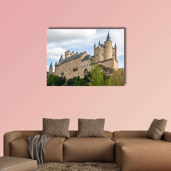 Alcazar of Segovia Castle Canvas Wall Art in beige, green and blue, single panel hung on a wall