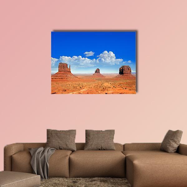 Buttes of Monument Valley Canvas Wall Art in brown, orange and blue, single panel hung on a wall