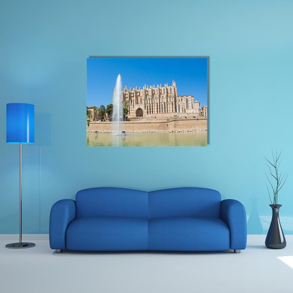 Palma De Mallorca Cathedral Fountain Canvas Wall Art in beige, brown and blue, single panel hung on a wall