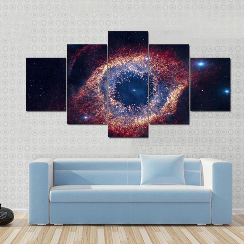 The Helix Nebula Eye of God Canvas Wall Art in black, red and blue, 5 panel Star layout hung on a wall