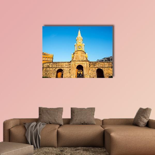 Historic Clock Tower Gate Canvas Wall Art in brown, yellow and blue, single panel hung on a wall