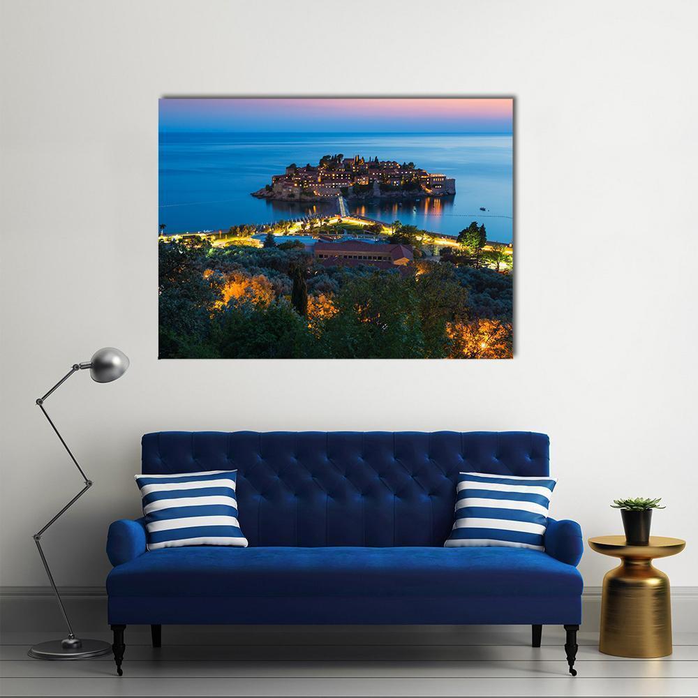 Sveti Stefan Island at Twilight Canvas Wall Art in orange, blue and navy, single panel hung on a wall