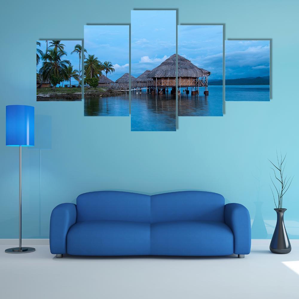 Overwater Bungalows in Blue Water Canvas Wall Art in blue, 5 panel Star layout hung on a wall