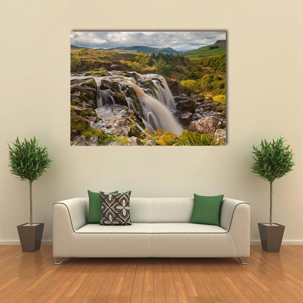 Loup of Fintry Waterfall Canvas Wall Art in gray, brown and green, single panel hung on a wall