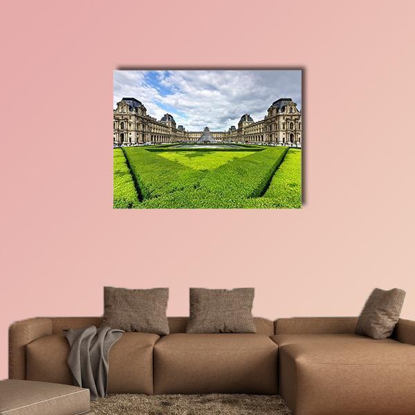 Louvre Museum and Glass Pyramid Canvas Wall Art in beige, green and blue, single panel hung on a wall