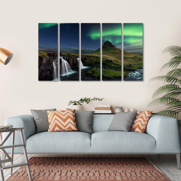 Northern Lights Over Mountain and Waterfalls Canvas Wall Art in black, green and blue, hung on a wall