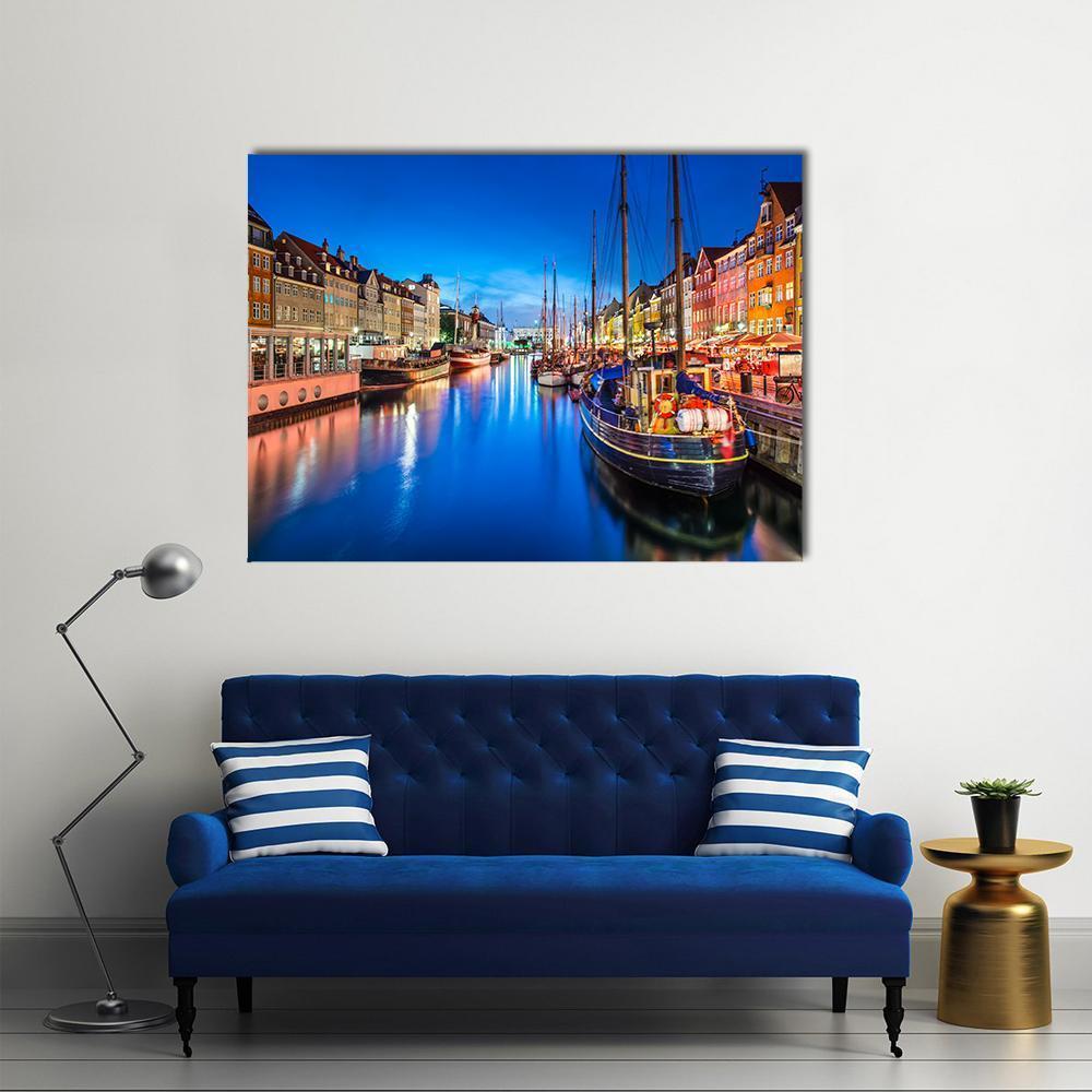 Vibrant Nyhavn Canal Scene at Night Canvas Wall Art in yellow, blue and multicolor, single panel hung on a wall
