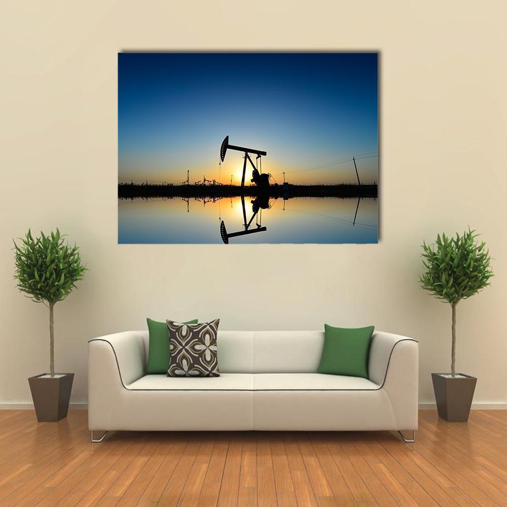 Oil Pump Silhouette at Sunset Canvas Wall Art in black, orange and blue, single panel hung on a wall