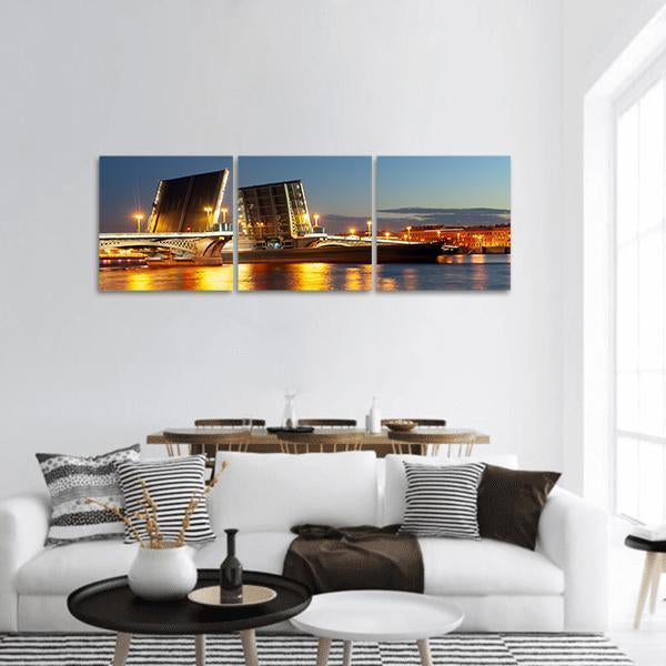 Raised Blagoveshchensky Bridge at Night Panoramic Canvas Wall Art in black, yellow and blue, hung on a wall
