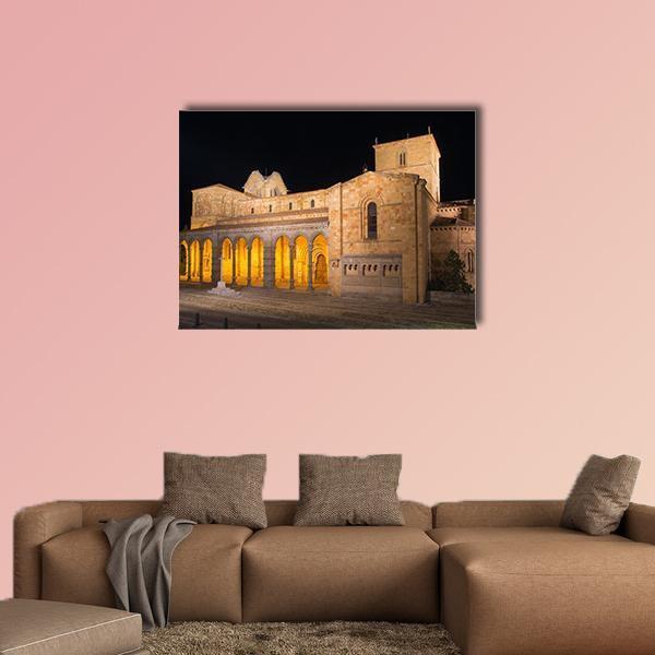 Romanesque Basilica at Night Canvas Wall Art in black, brown and yellow, single panel hung on a wall