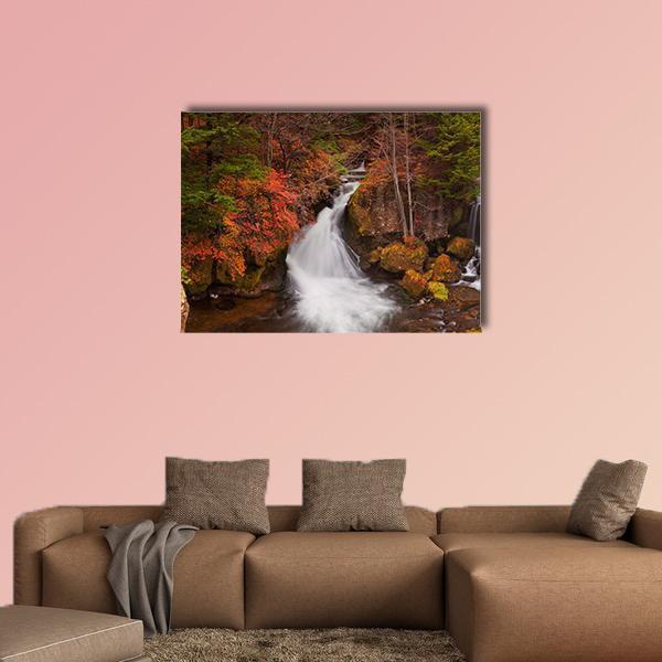 Ryuzu Falls Autumn Waterfall Canvas Wall Art in brown, orange and green, single panel hung on a wall