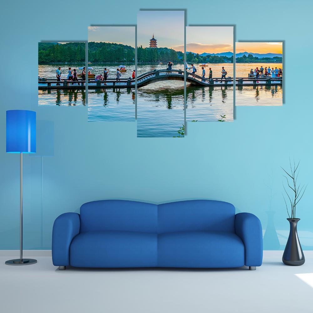 Pagoda and Arched Bridge at Sunset Canvas Wall Art in orange, yellow and blue, 5 panel Star layout hung on a wall