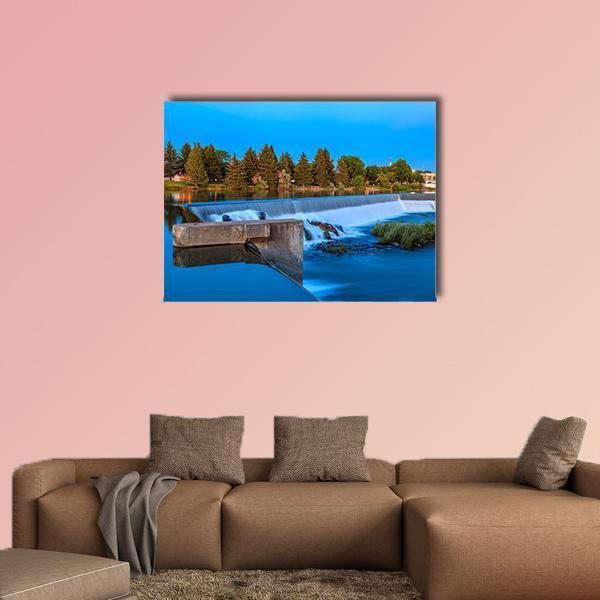 Small Waterfall on River with Trees Canvas Wall Art in green and blue, single panel hung on a wall