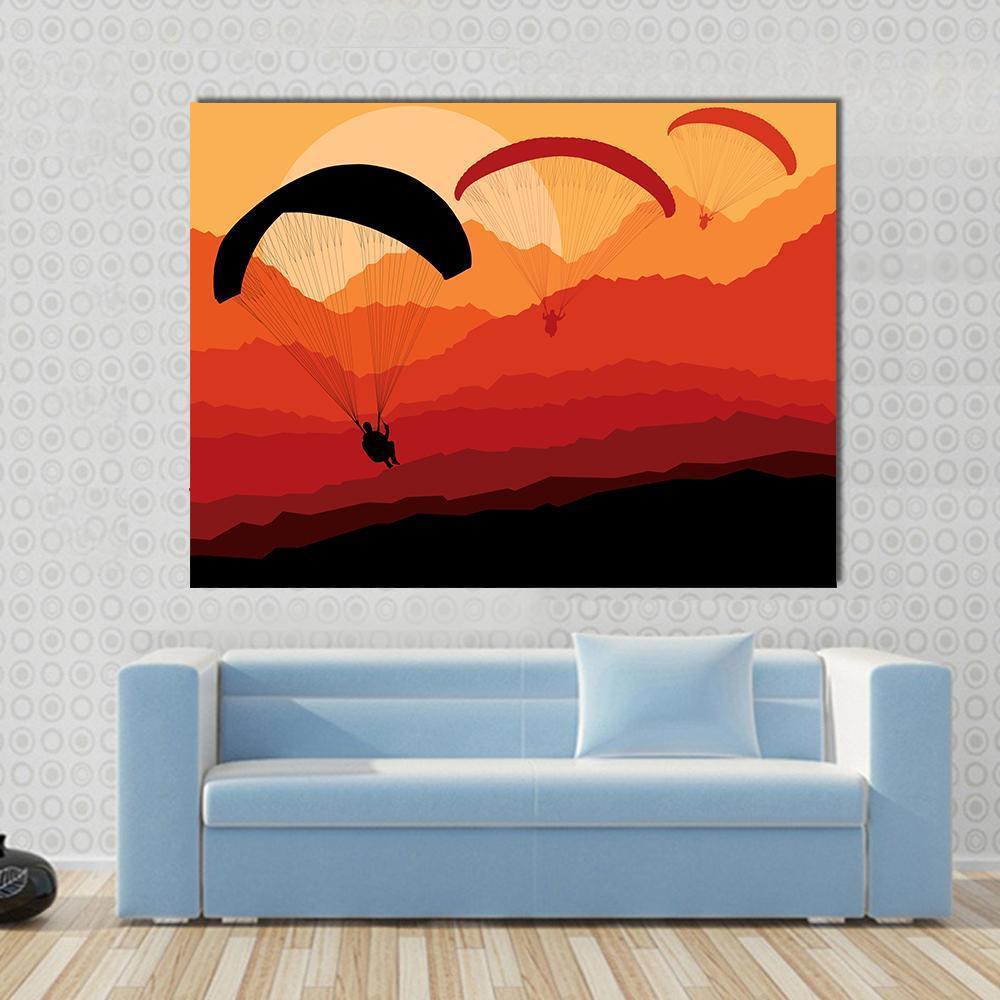 Three Paragliders Over Mountains Canvas Wall Art in black, red and orange, single panel hung on a wall
