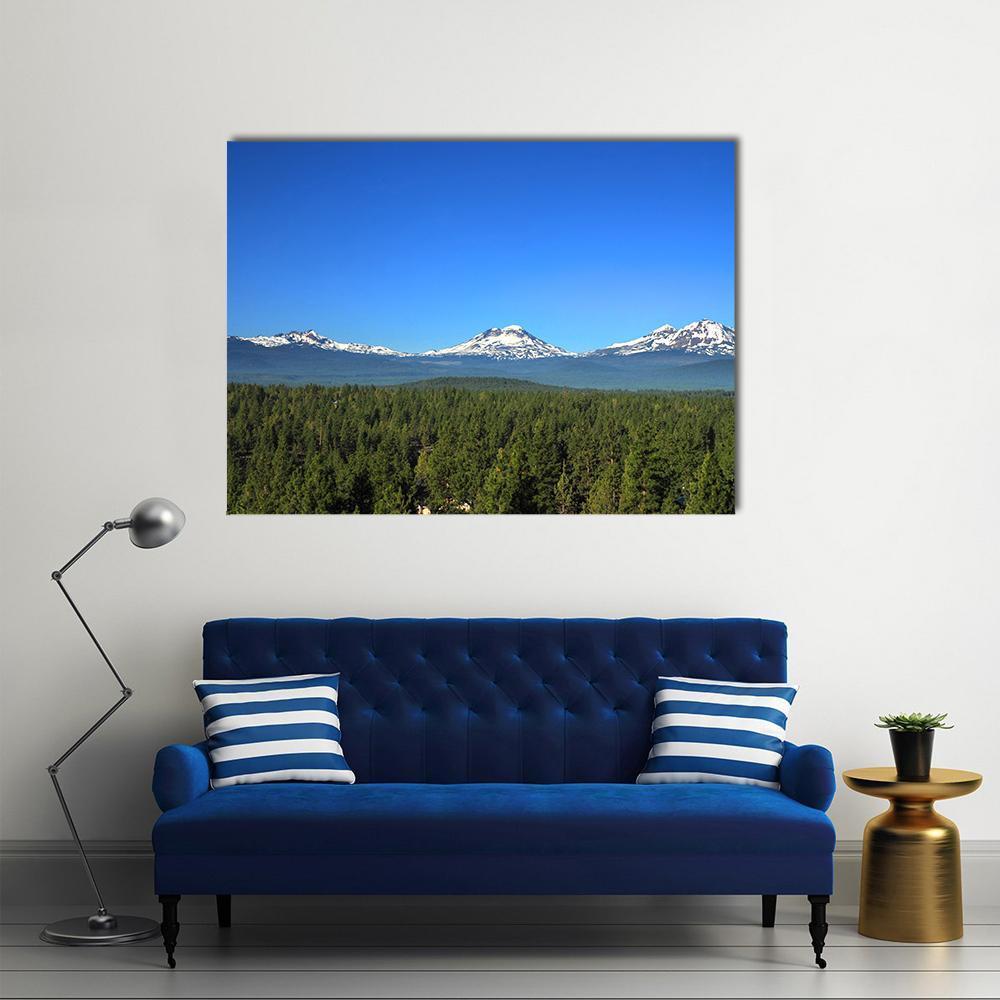 Three Sisters Mountains Oregon Canvas Wall Art in white, green and blue, single panel hung on a wall