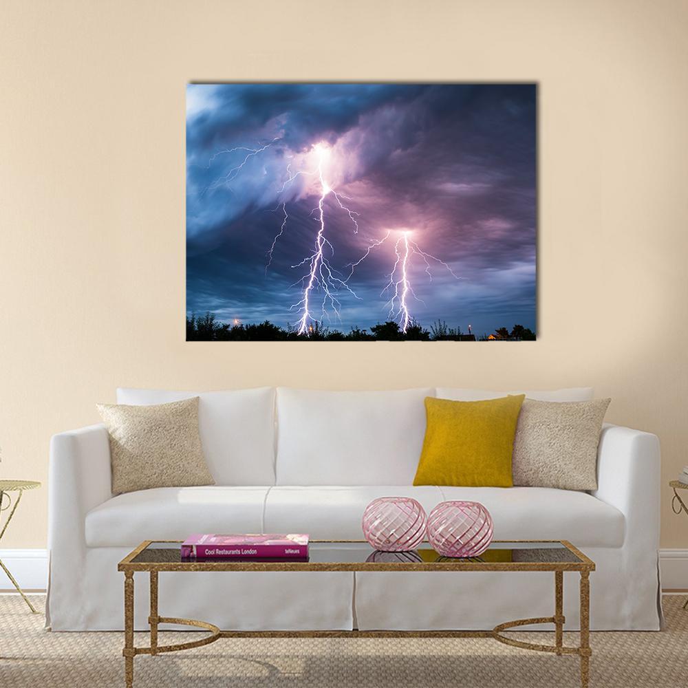 Dramatic Lightning Strike Over Dark Clouds Canvas Wall Art in black, blue and purple, single panel hung on a wall