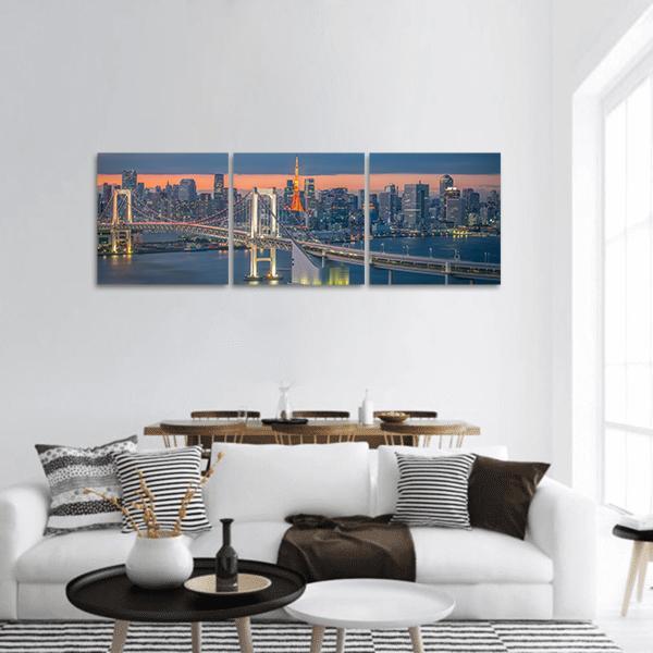 Tokyo Rainbow Bridge at Dusk Panoramic Canvas Wall Art in gray, orange and blue, hung on a wall