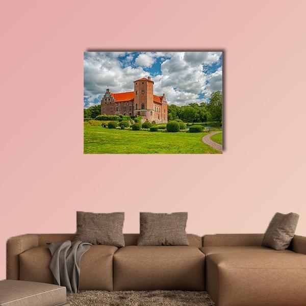 Torup Castle in Sweden Canvas Wall Art in red, green and blue, single panel hung on a wall