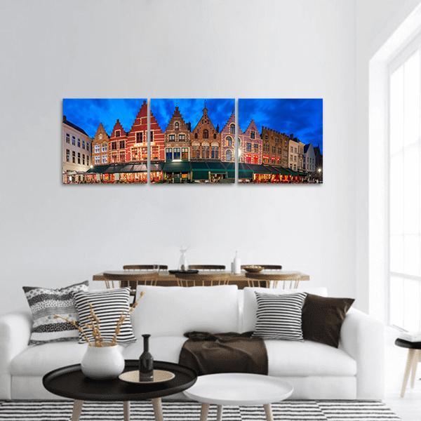 Medieval Fairytale Town at Twilight Panoramic Canvas Wall Art in brown, red and blue, hung on a wall