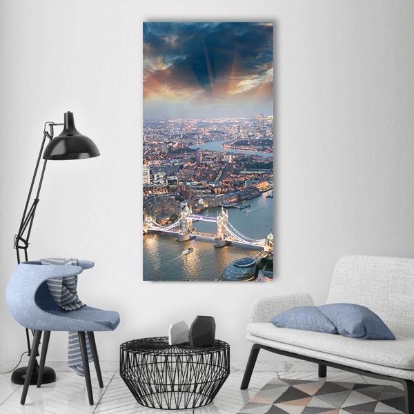 Aerial View of Tower Bridge at Sunset Vertical Canvas Wall Art in gray, orange and blue, single vertical panel hung on a wall