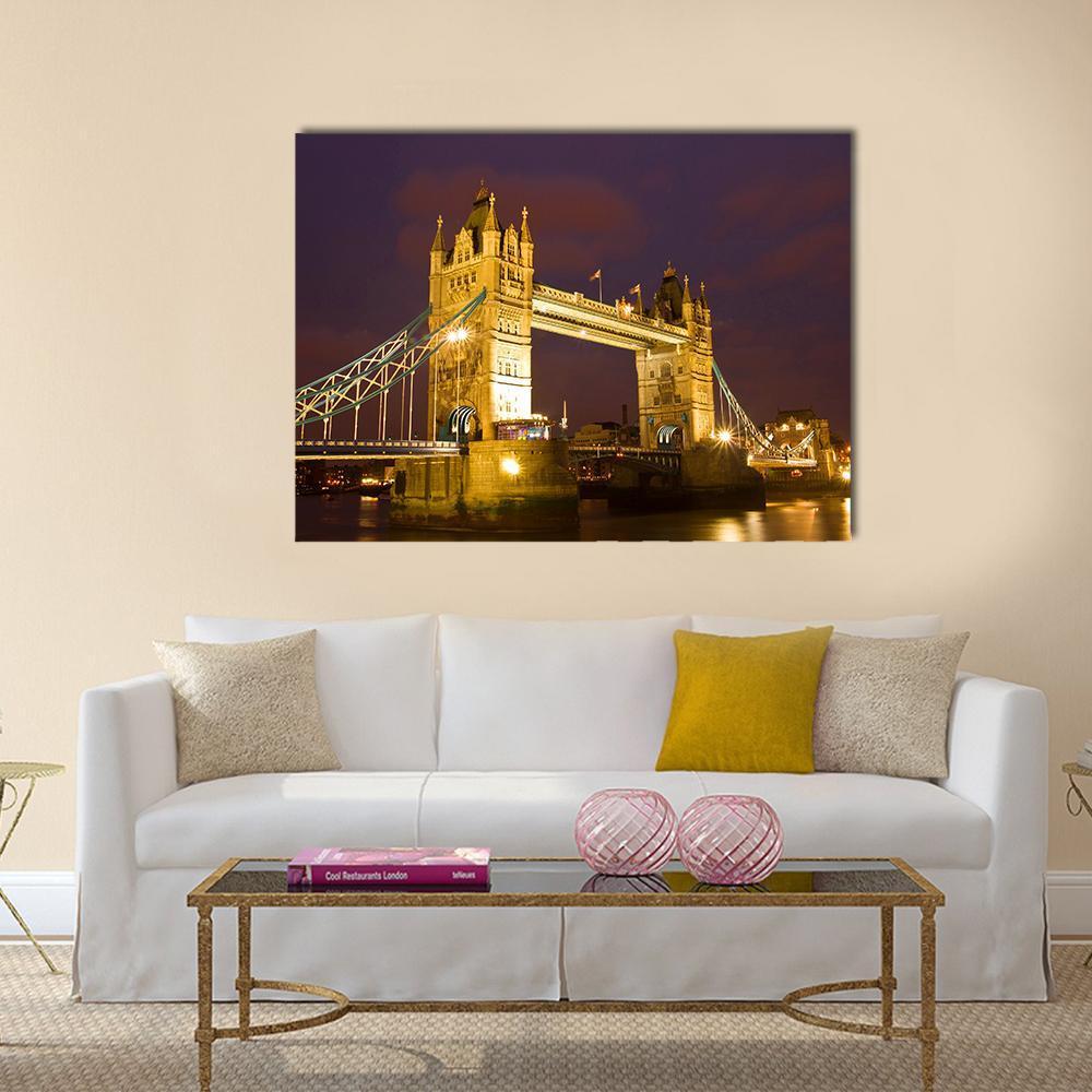 Tower Bridge Illuminated at Twilight Canvas Wall Art in gold, yellow and purple, single panel hung on a wall