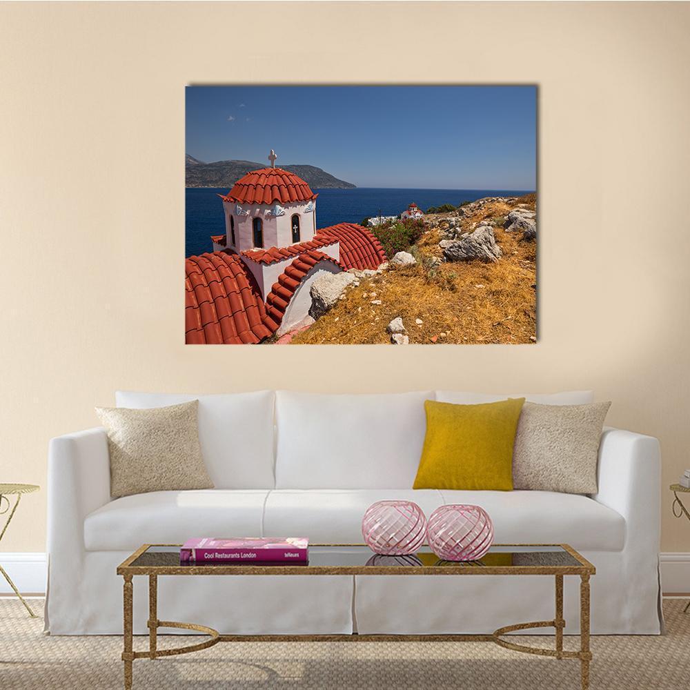 White Church with Red Roof by the Sea Canvas Wall Art in white, red and blue, single panel hung on a wall