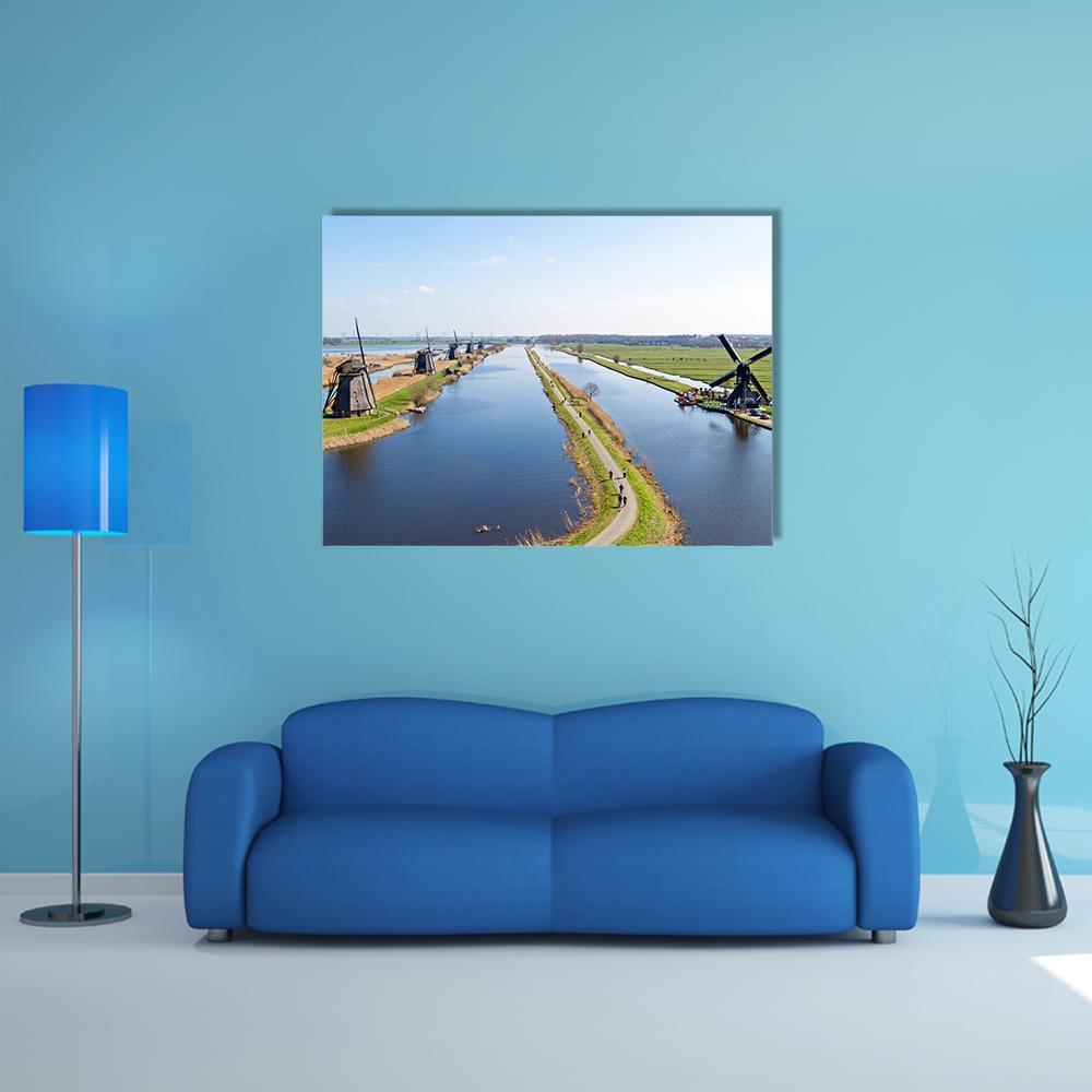 Traditional Dutch Windmills Along Canal Canvas Wall Art in white, green and blue, single panel hung on a wall
