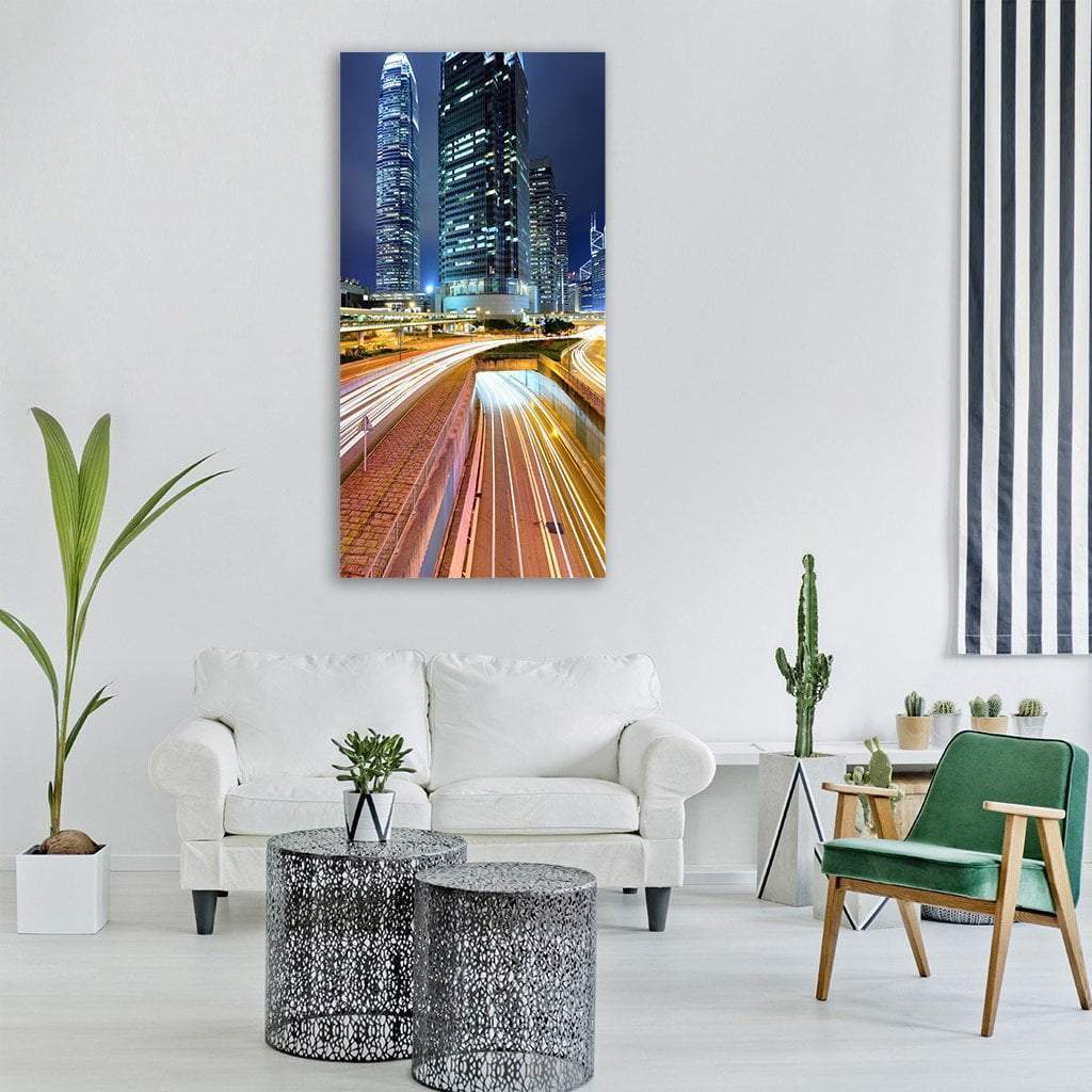 Dubai Night Traffic with Light Trails Vertical Canvas Wall Art in black, yellow and blue, single vertical panel hung on a wall
