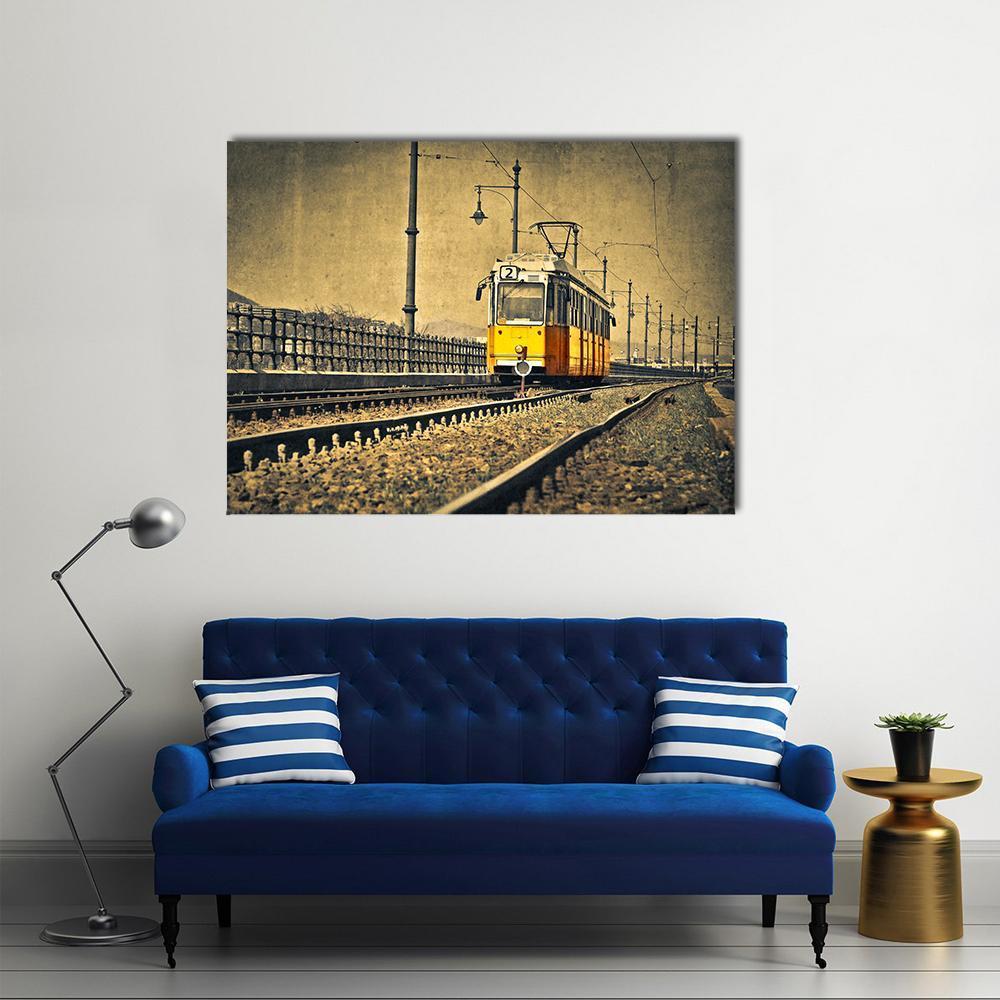 Vintage Tram on Railway Tracks in Budapest Canvas Wall Art in gray, beige and yellow, single panel hung on a wall