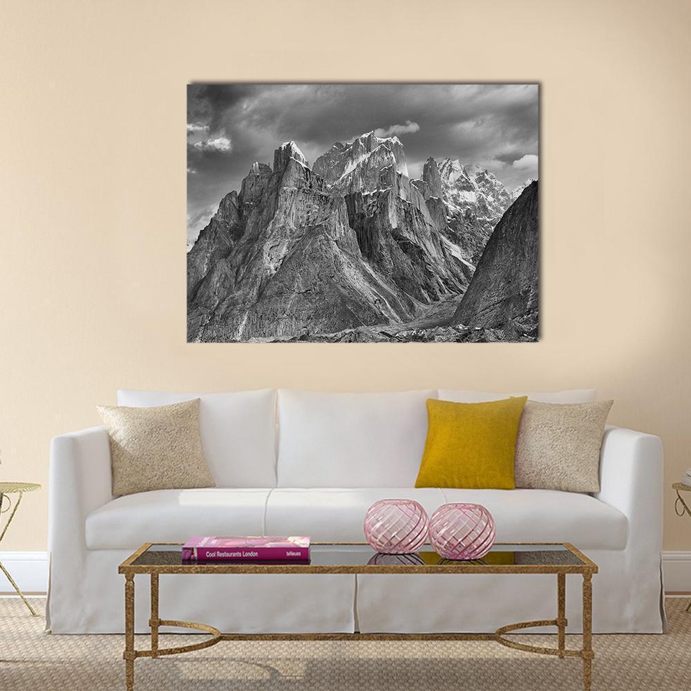 Trango Towers Beneath Dramatic Clouds Canvas Wall Art in black, white and gray, single panel hung on a wall