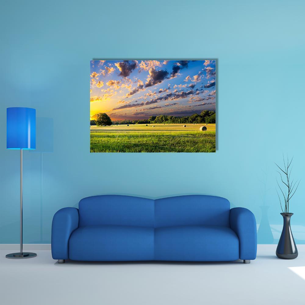 Tranquil Meadow at Sunrise Canvas Wall Art in yellow, green and blue, single panel hung on a wall