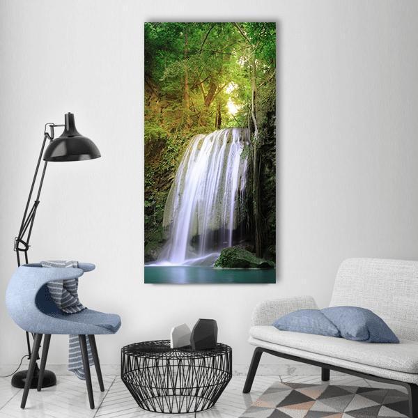 Tranquil Waterfall in Lush Forest Vertical Canvas Wall Art in white, green and blue, single vertical panel hung on a wall