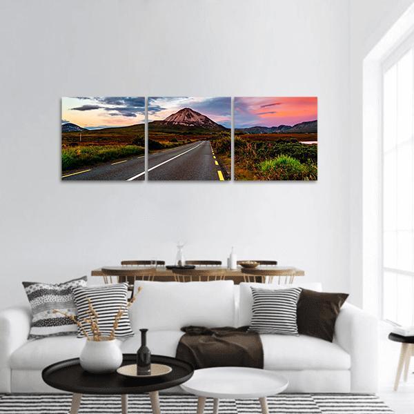 Mount Errigal at Sunset Panoramic Canvas Wall Art in orange, green and blue, hung on a wall