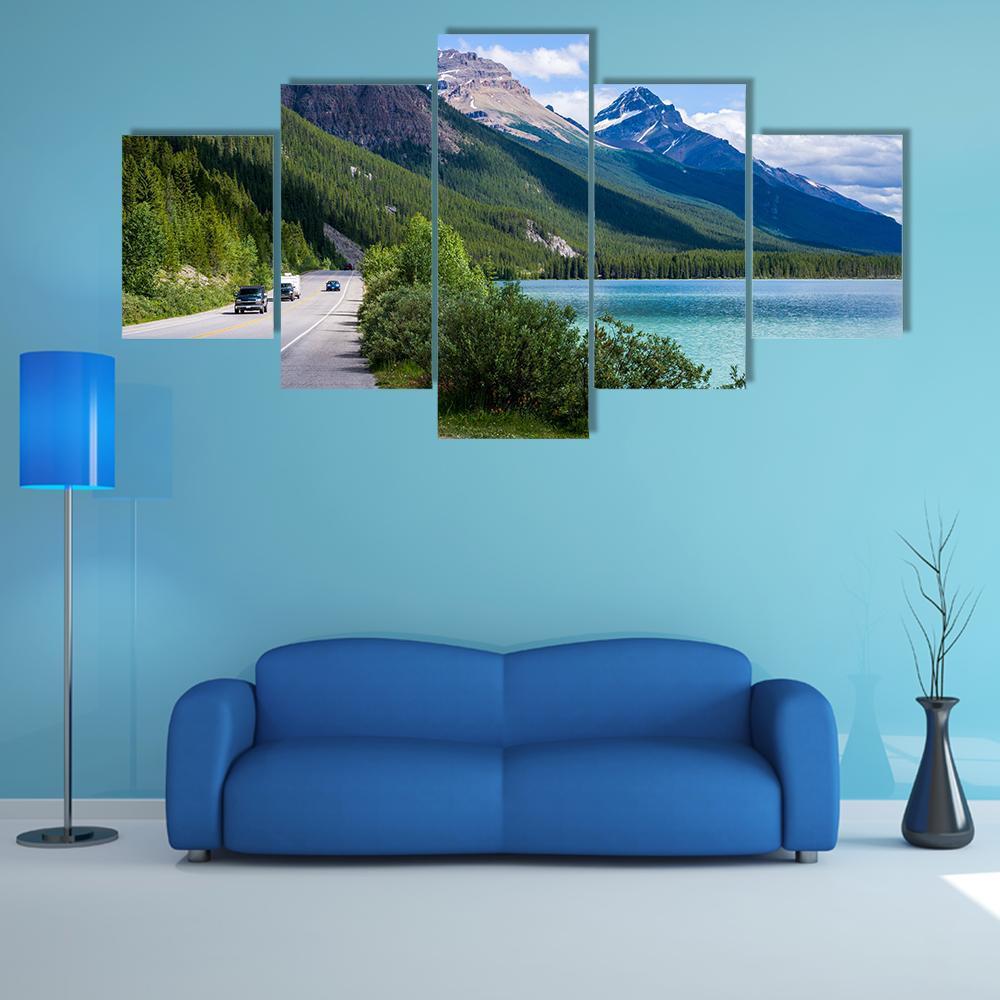 Travelers Along Mountain Lake Road Canvas Wall Art in gray, green and blue, 5 panel Star layout hung on a wall