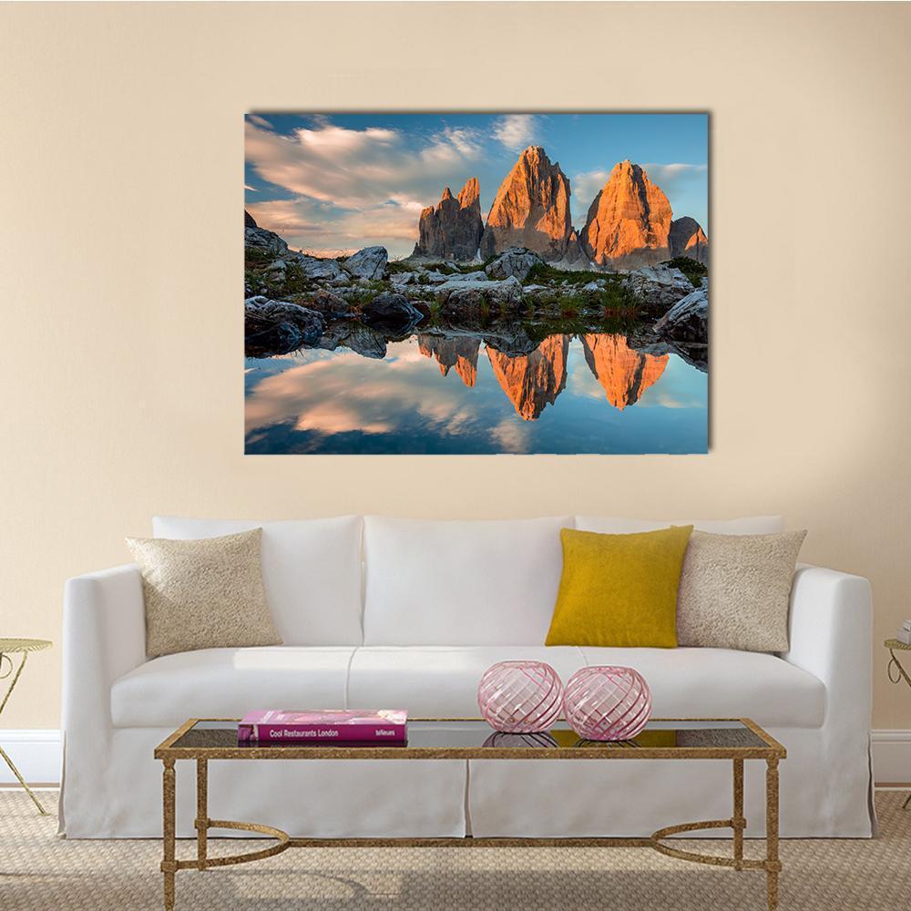 Tre Cime Reflected in Lake Canvas Wall Art in brown, orange and blue, single panel hung on a wall