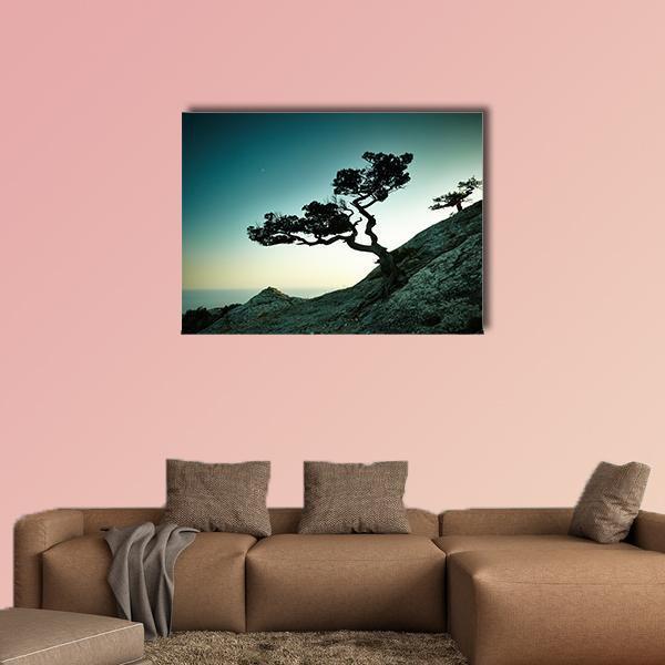 Tree and Sea at Sunset Canvas Wall Art in black, gray and blue, single panel hung on a wall