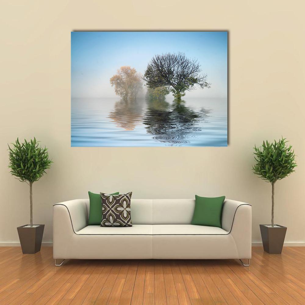 Misty Lake Trees with Autumn Foliage Canvas Wall Art in gray, brown and blue, single panel hung on a wall