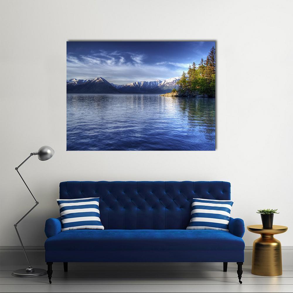 Trees Reflected on Mountain Lake Canvas Wall Art in white, green and blue, single panel hung on a wall